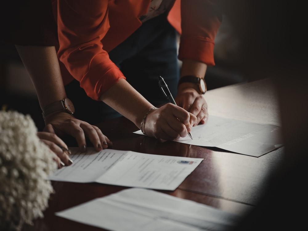 image of two people signing papers